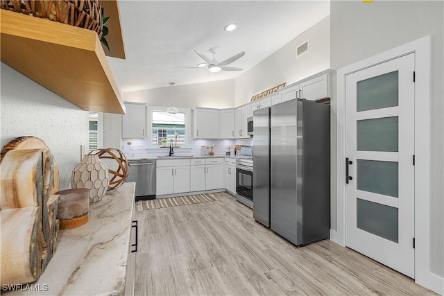 kitchen featuring light stone counters, visible vents, ceiling fan, appliances with stainless steel finishes, and tasteful backsplash