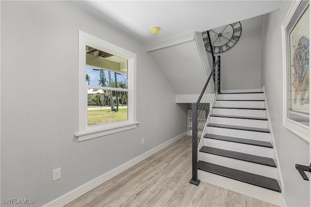 stairway with baseboards and wood finished floors