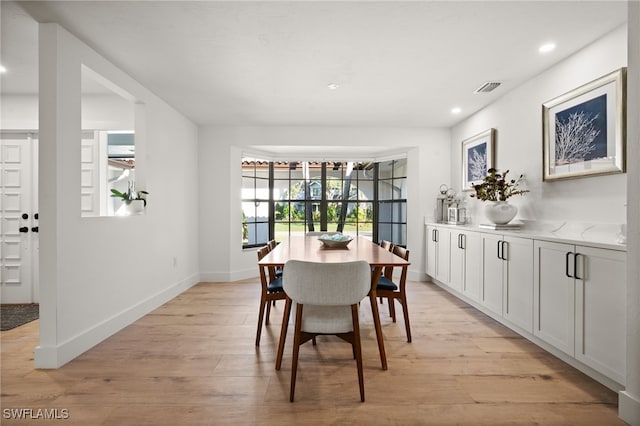 dining area with recessed lighting, light wood-type flooring, baseboards, and visible vents