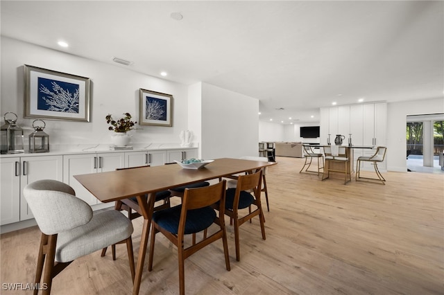 dining area featuring light wood finished floors, visible vents, and recessed lighting