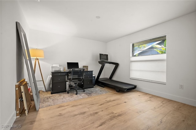 office featuring baseboards and light wood-style flooring