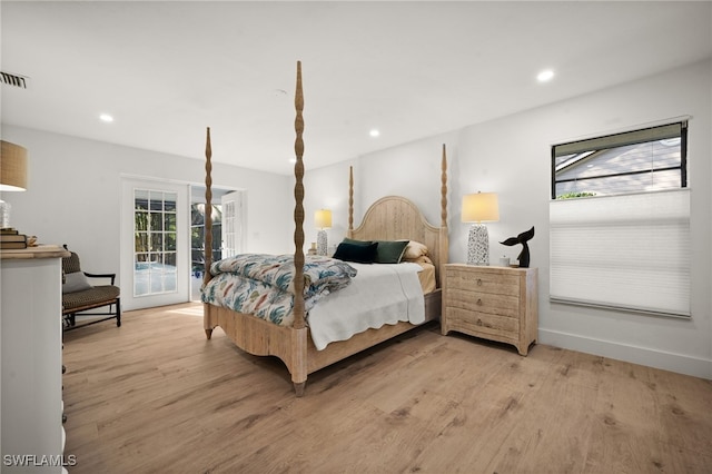 bedroom with access to exterior, recessed lighting, multiple windows, and light wood-type flooring