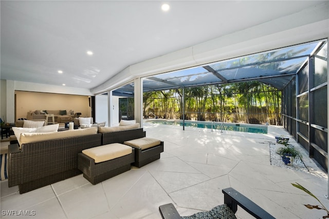 view of pool featuring outdoor lounge area, a patio, a fenced in pool, and a lanai