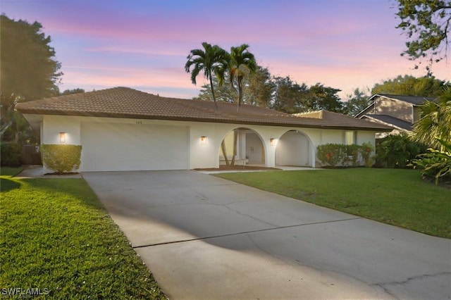145 Forestwood Dr, Naples, FL 34110 - single story home with a tiled roof, a garage, a yard, driveway, and stucco siding