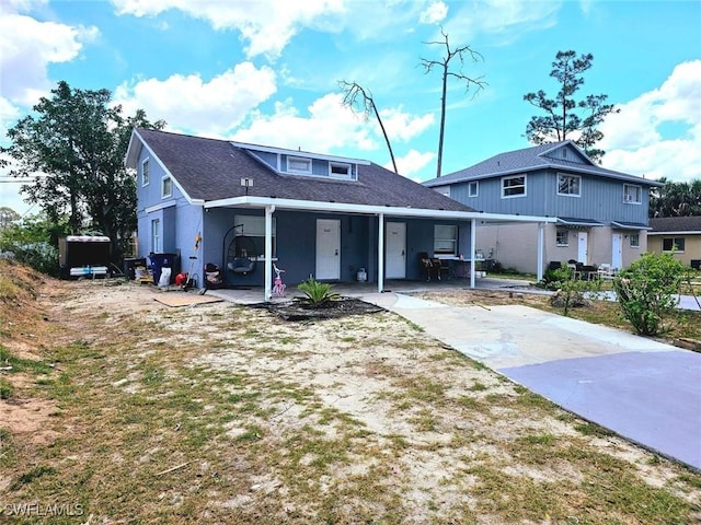 5529/5531 10th Ave, Fort Myers, FL 33907 - view of front of house with a porch, concrete driveway, and a shingled roof