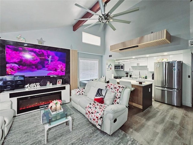 5529/5531 10th Ave, Fort Myers, FL 33907 - living room with beamed ceiling, a ceiling fan, high vaulted ceiling, and wood finished floors