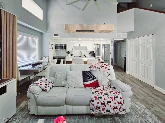 5529/5531 10th Ave, Fort Myers, FL 33907 - living room with a towering ceiling, wood finished floors, ceiling fan, and baseboards
