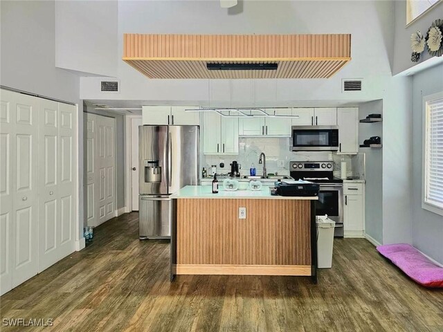 5529/5531 10th Ave, Fort Myers, FL 33907 - kitchen with stainless steel appliances, white cabinetry, and dark wood-style flooring