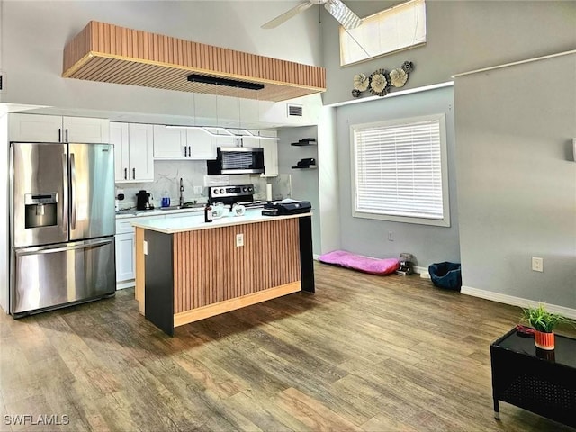 5529/5531 10th Ave, Fort Myers, FL 33907 - kitchen featuring stainless steel appliances, dark wood-type flooring, a high ceiling, ceiling fan, and white cabinetry