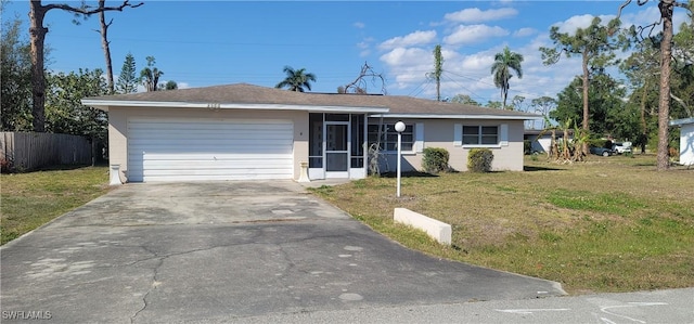 single story home with a front lawn, fence, a garage, a sunroom, and driveway