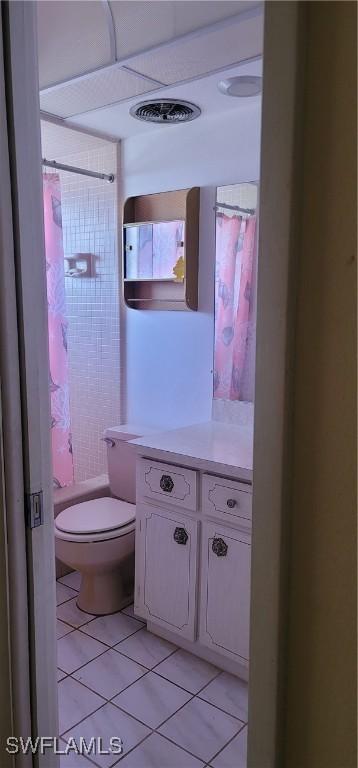 bathroom with tile patterned flooring, toilet, and vanity