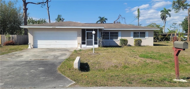 ranch-style house with an attached garage, driveway, a front lawn, and fence