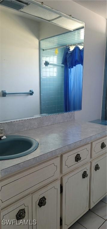 bathroom with tile patterned floors and vanity