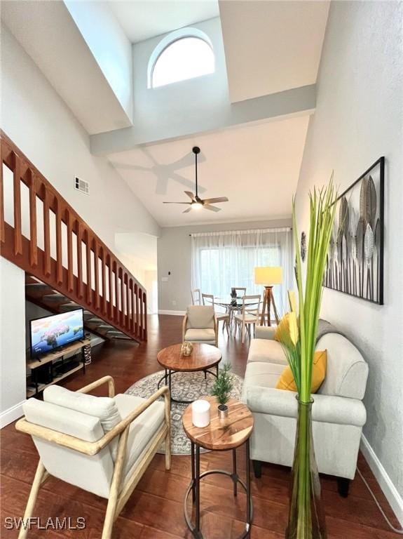 living room featuring baseboards, stairs, ceiling fan, and high vaulted ceiling