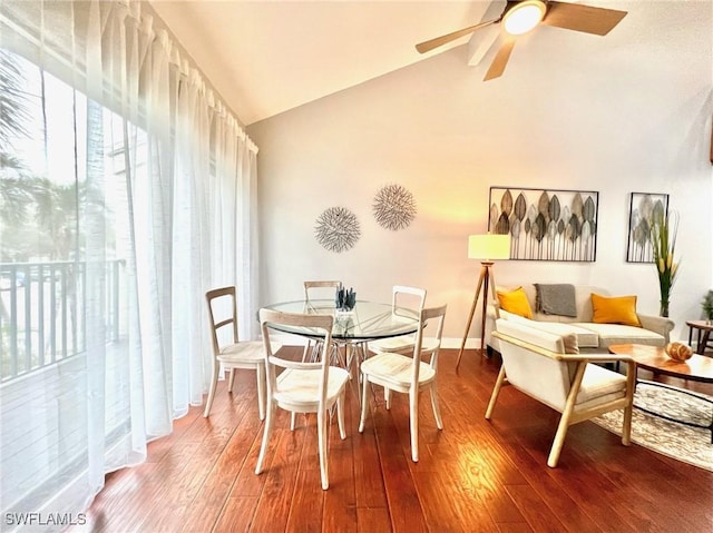 dining area with high vaulted ceiling, ceiling fan, and wood finished floors