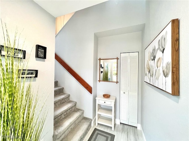 stairway featuring baseboards and wood finished floors