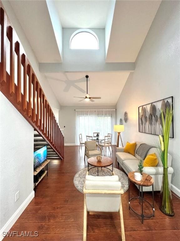 living area with stairs, wood finished floors, baseboards, and ceiling fan