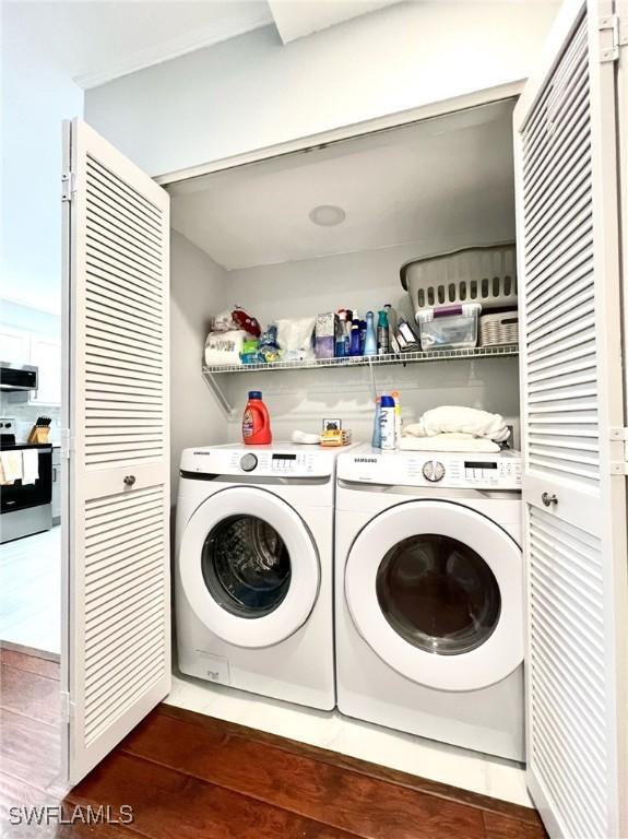 washroom with laundry area, dark wood-style floors, and washing machine and clothes dryer