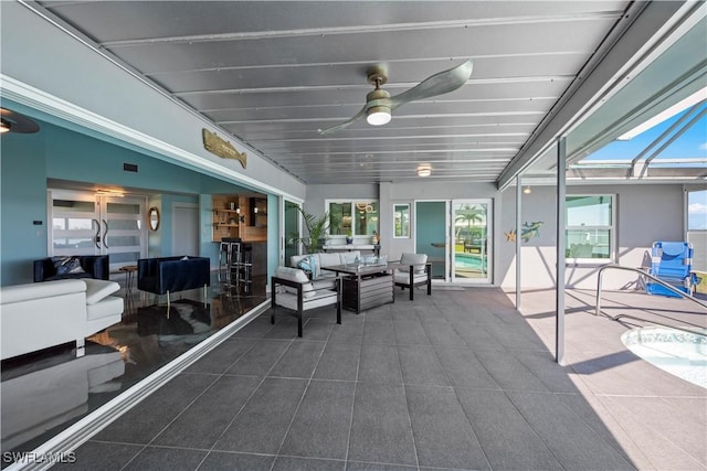 view of patio / terrace with glass enclosure and ceiling fan