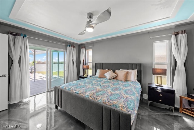 bedroom featuring baseboards, a raised ceiling, a ceiling fan, and access to outside