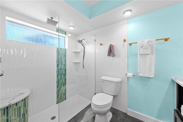 full bath featuring baseboards, toilet, vanity, and walk in shower