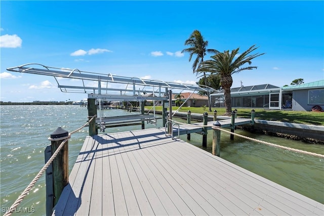 dock area with a water view and boat lift