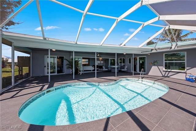 pool with glass enclosure and a patio