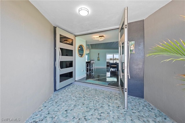 entrance to property featuring stucco siding