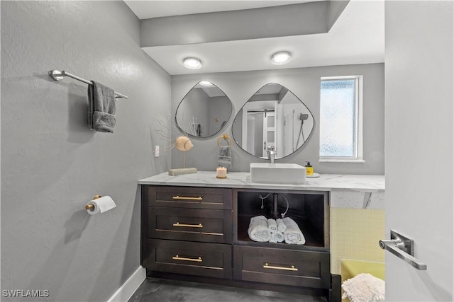 bathroom featuring baseboards and vanity