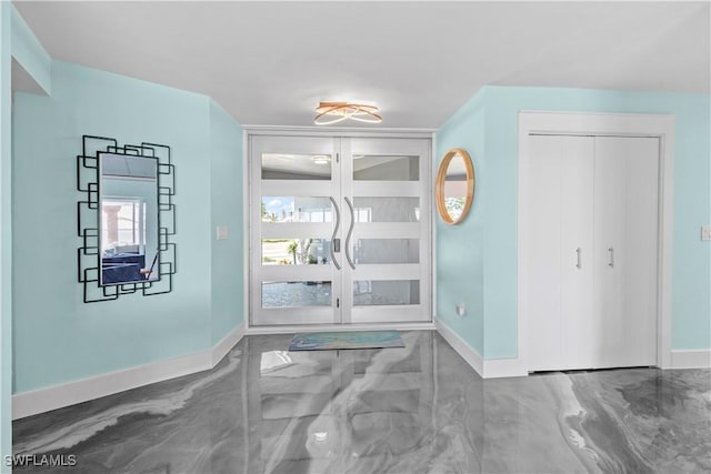 interior space featuring marble finish floor and baseboards