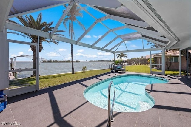 pool with a patio area, a lanai, a yard, and a water view