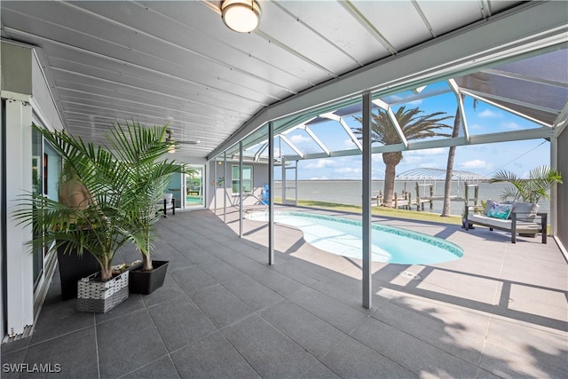 outdoor pool with a patio, a ceiling fan, and a lanai