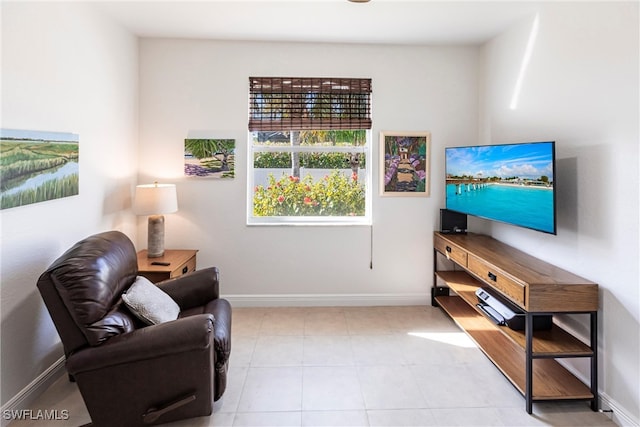 sitting room featuring tile patterned flooring and baseboards