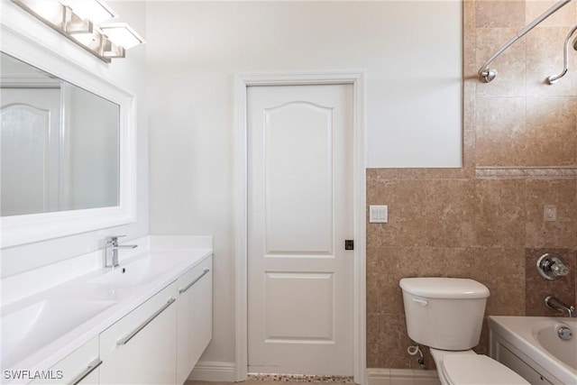 bathroom featuring double vanity, a sink, tile walls, toilet, and shower / bathtub combination