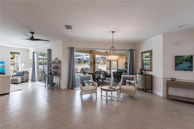 dining room featuring a ceiling fan, baseboards, visible vents, a textured ceiling, and crown molding