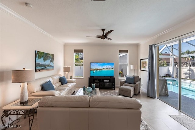 living area featuring crown molding, plenty of natural light, and a ceiling fan