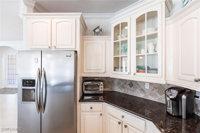 kitchen featuring glass insert cabinets, tasteful backsplash, stainless steel fridge with ice dispenser, and white cabinetry