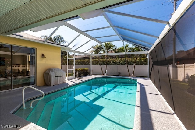 view of swimming pool with a patio area, a fenced in pool, a grill, and glass enclosure