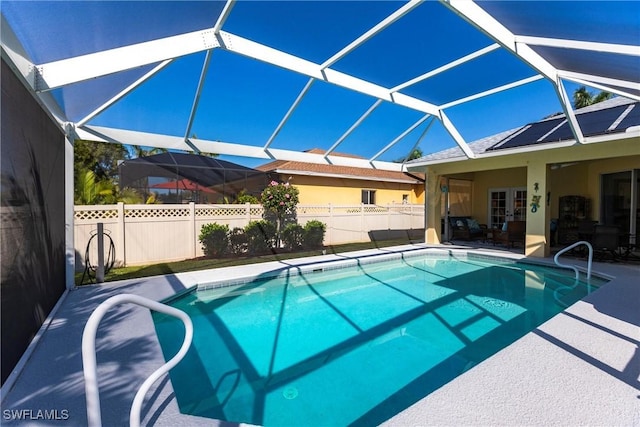 view of swimming pool with a patio, a fenced backyard, a fenced in pool, and a lanai