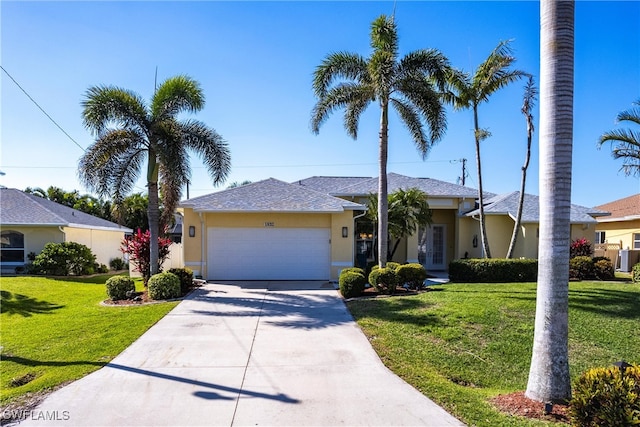 ranch-style home featuring stucco siding, french doors, concrete driveway, a front yard, and a garage