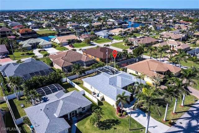 drone / aerial view with a residential view and a water view