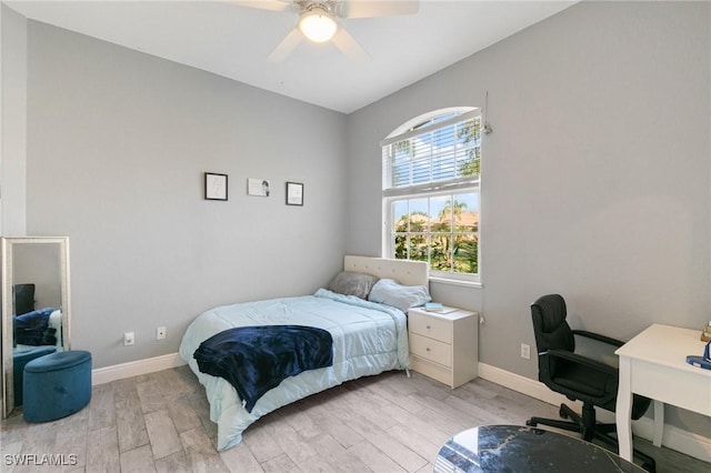 bedroom with baseboards, light wood-style flooring, and a ceiling fan