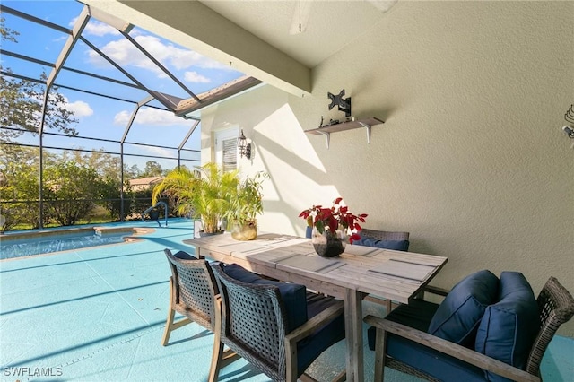 view of patio / terrace with outdoor dining space, a lanai, an outdoor pool, and a hot tub