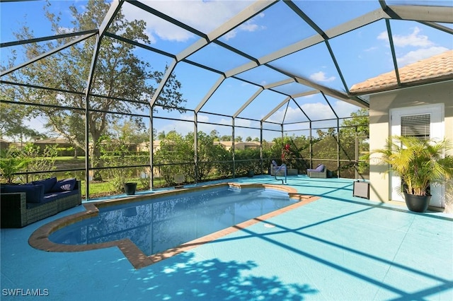 pool with a patio area and glass enclosure