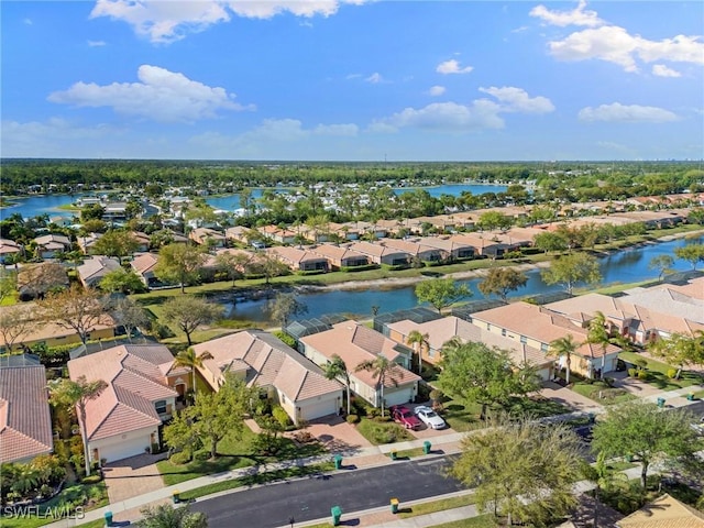 drone / aerial view featuring a residential view and a water view