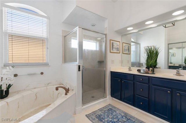 full bath featuring a bath, a stall shower, double vanity, and a sink