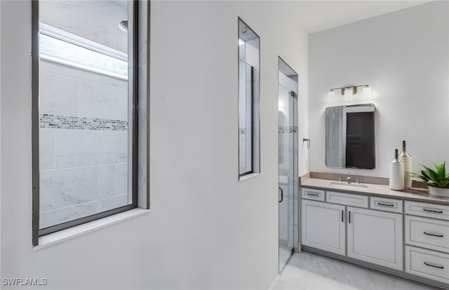 bathroom featuring a stall shower and vanity