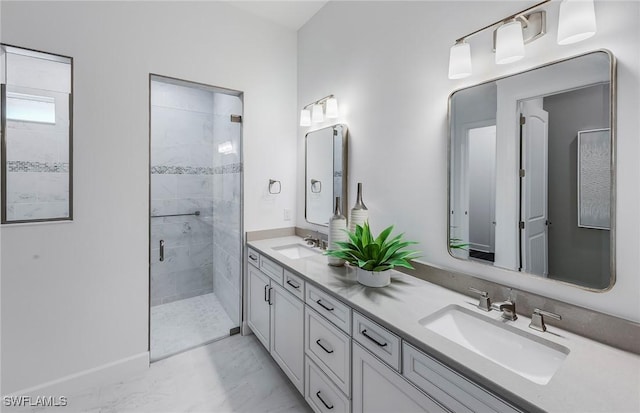 bathroom featuring double vanity, marble finish floor, a stall shower, and a sink