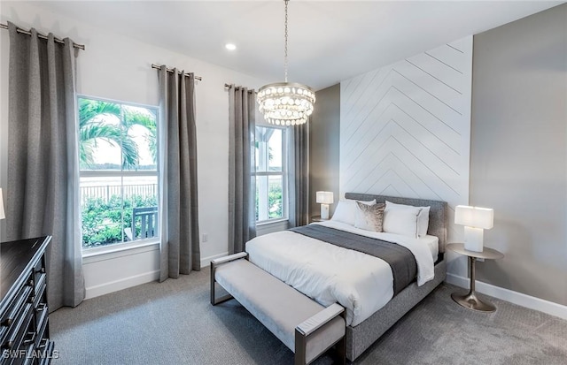 carpeted bedroom with baseboards, multiple windows, and an inviting chandelier