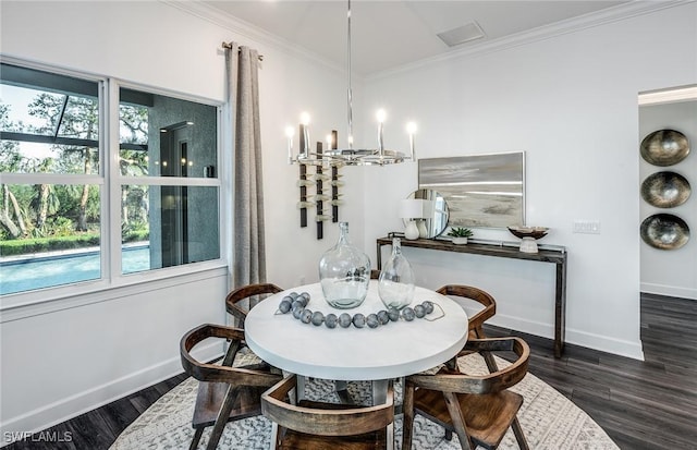 dining space featuring baseboards, an inviting chandelier, wood finished floors, and crown molding